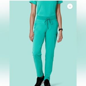 Surgical green scrub set with Mandala 6 Pocket Slim Pants and Figs 1 pocket top.